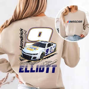 May include: Beige sweatshirt featuring a graphic of a white race car with the number 9 and the name "Chase Elliott." The back of the sweatshirt displays the Hendrick Motorsports logo and the word "ELLIOTT" in blue. The front has the word "NASCAR" in red, yellow, and blue.
