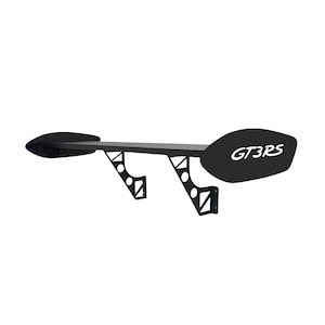 May include: Black car spoiler with the text "GT3RS" in white. The spoiler has a long, flat main section with curved end pieces. It is supported by two angled brackets with cut-out designs.