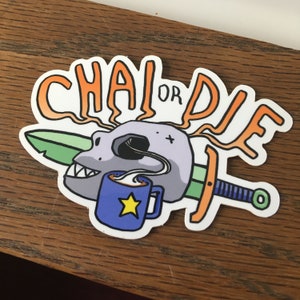 May include: A sticker with a skull drinking from a blue mug with a yellow star. The skull has a sword through it and the text "Chai or Die" is above the skull.