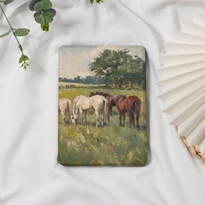 May include: A rectangular case featuring an impressionistic painting of horses grazing in a field. The artwork depicts several horses, including white and brown ones, in a green pasture under a cloudy sky. The style is reminiscent of classic landscape art.