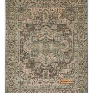 May include: Rectangular area rug with an intricate, distressed pattern in shades of brown, beige, and teal. The rug features a central medallion design and a detailed border. The tag in the corner reads "HANKWOVEN".
