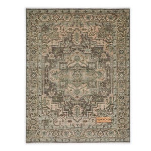 May include: Rectangular area rug with an intricate, distressed pattern in shades of brown, beige, and green. The rug features a central medallion design and a detailed border. The tag in the image reads "HANKWOVEN".
