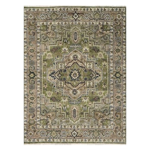May include: Rectangular area rug with an intricate, traditional design. The rug features a central medallion in shades of green, brown, and blue, surrounded by a detailed border. The overall color palette is muted, with a blend of greens, tans, and blues.