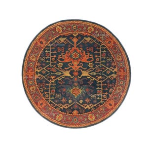May include: A round rug with an intricate, traditional design. The rug features a dark blue center with orange and yellow floral and geometric patterns. A border of red and orange frames the central design, creating a warm, inviting aesthetic.