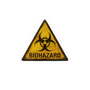 May include: A yellow triangular sticker with a black biohazard symbol and the word "BIOHAZARD" in black text. The sticker has a distressed, aged appearance, suggesting a warning label.