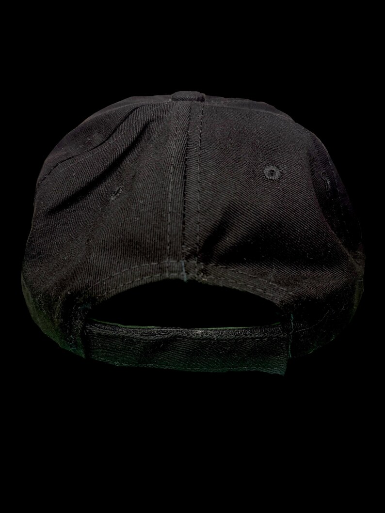May include: A black baseball cap with a curved peak and an adjustable strap. The cap is made from a sturdy material and has a structured crown. The back of the cap has an adjustable strap for a comfortable fit.