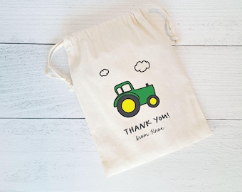 May include: A white cotton drawstring bag with a green tractor design and the text "THANK YOU! from Kose" printed on it.
