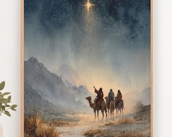 May include: A framed watercolor painting depicting three figures riding camels across a desert landscape toward a bright star in a dark, starry night sky. The scene features rugged mountains in the background and dry, golden-brown desert vegetation.