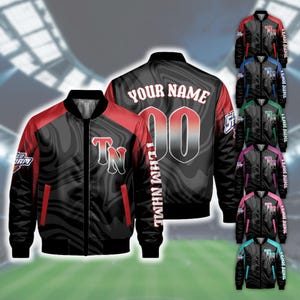 May include: A black and red varsity jacket featuring a marbled pattern, a front zipper, and ribbed collar and cuffs. The back displays the text YOUR NAME and the number 00, while the front features the letters TN and the text TEHM NHMIE.