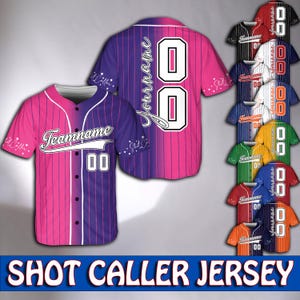 May include: A pink and purple baseball jersey with white stripes and a white "Teamname" and number "00" on the front. The jersey has a pink and purple ombre design. The text "Shot Caller Jersey" is at the bottom of the image.