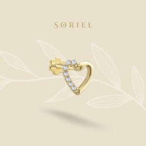 May include: A gold heart-shaped earring with a single row of small clear diamonds around the edge.