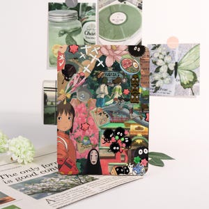 May include: A colorful collage featuring characters and scenes from the animated film Spirited Away. The design includes images of characters, food, and Japanese text, set against a backdrop of flowers and other decorative elements.