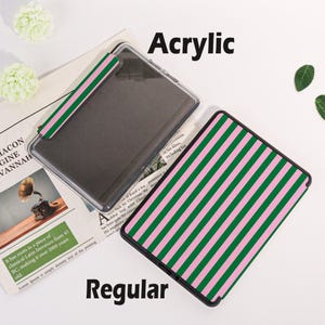May include: Two rectangular cases, one clear acrylic and one regular, are displayed. The regular case features a pink and green striped pattern. The acrylic case has a matching pink and green striped band. The word "Acrylic" is above the acrylic case and the word "Regular" is below the regular case.