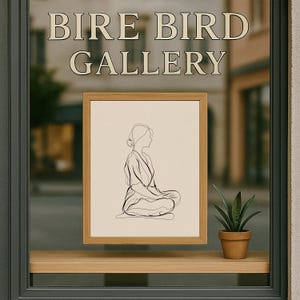 May include: A framed line art print of a seated figure in a wooden frame. The artwork is displayed in a window with the text "BIRE BIRD GALLERY" above. A small potted plant sits on a wooden shelf below the artwork.