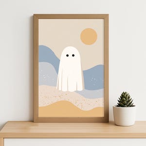May include: A framed art print with a minimalist design. It depicts a white ghost figure set against abstract blue and tan shapes, with a yellow sun. The artwork is presented in a wooden frame.