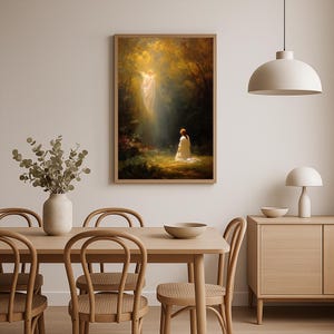 May include: A framed art print depicting a spiritual scene. The artwork shows a figure kneeling before a radiant, angelic form in a forest setting. The color palette is warm, with golden and green hues dominating the scene. The print is displayed in a light-colored wooden frame.