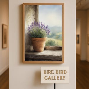 May include: A framed painting of a lavender plant in a terracotta pot on a wooden windowsill. The background shows a scenic view of a field and sky. The painting is displayed in a gallery setting.