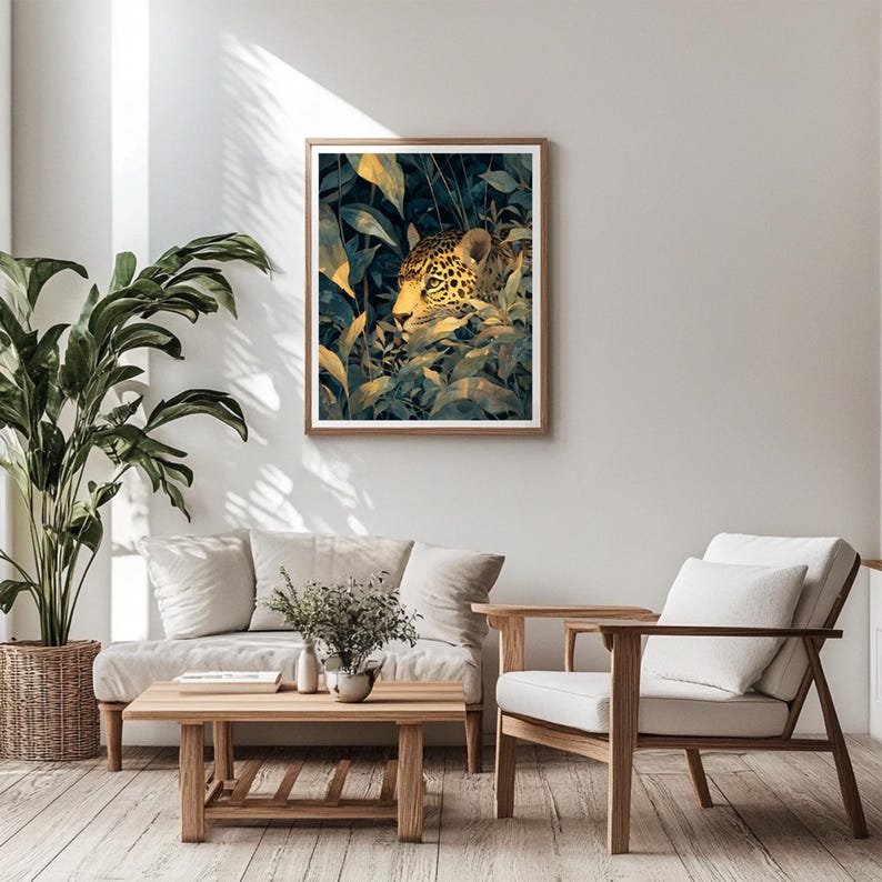 May include: A framed art print featuring a jaguar hidden in lush green and gold foliage. The artwork has a natural wood frame and is displayed in a modern living room setting with light-colored furniture and a large potted plant.