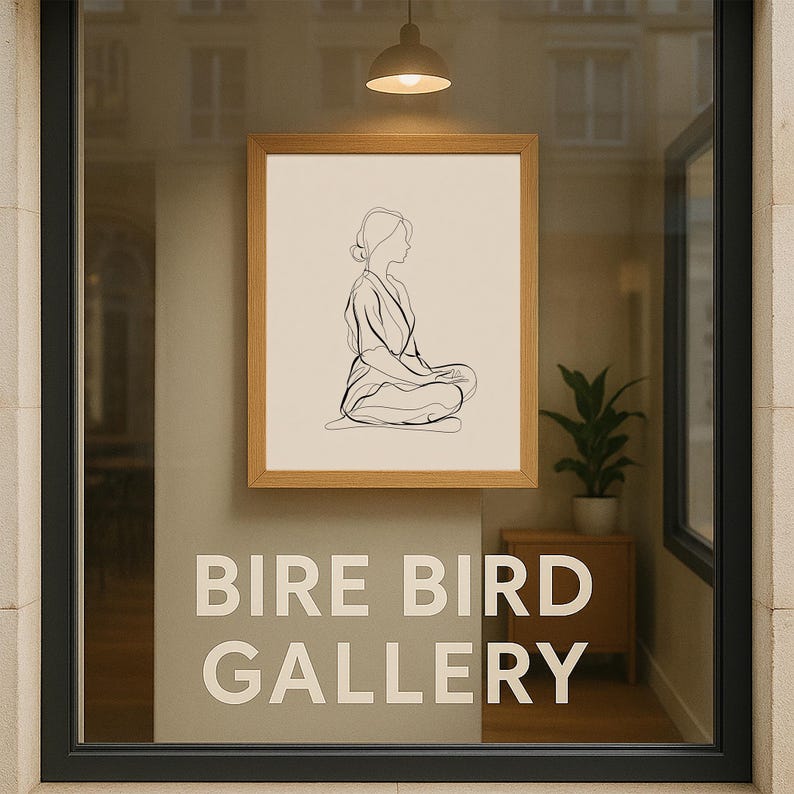 May include: A framed artwork featuring a minimalist line drawing of a seated figure in a meditative pose. The artwork is displayed in a window with the text "BIRE BIRD GALLERY" in large white letters. The frame is light brown.