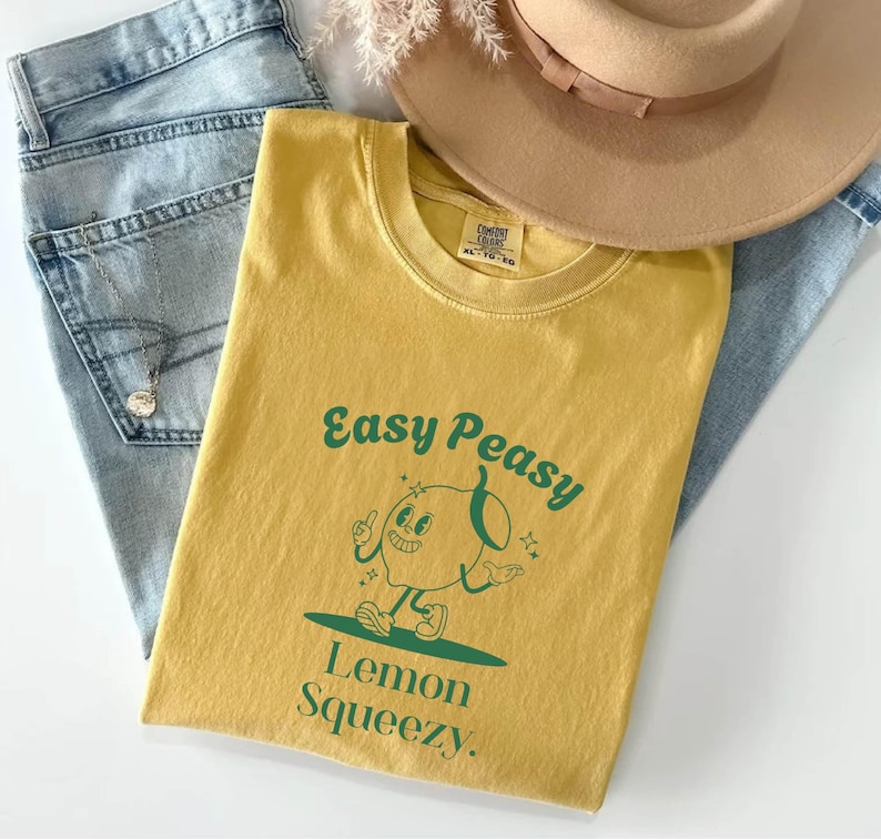 May include: A yellow t-shirt with a green cartoon lemon character and the text "Easy Peasy Lemon Squeezy."