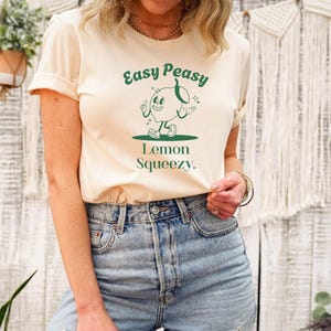 May include: A white t-shirt with a green graphic of a cartoon lemon with the text "Easy Peasy Lemon Squeezy."