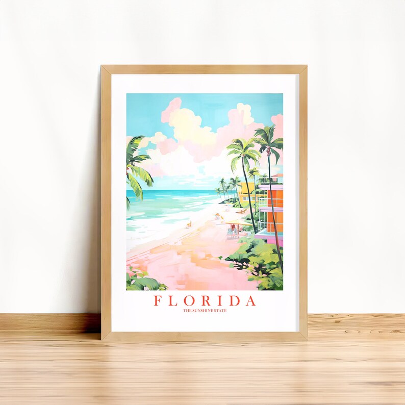 May include: A framed print of a colorful illustration of a beach scene in Florida. The print features palm trees, a beach, ocean, and buildings. The text "FLORIDA THE SUNSHINE STATE" is at the bottom of the print.
