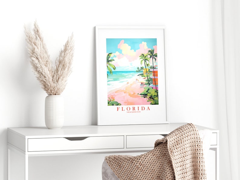 May include: A colorful illustration of a beach scene in Florida. The image features palm trees, a beach, and a pink sky with white clouds. The text "FLORIDA" is written in red at the bottom of the image.