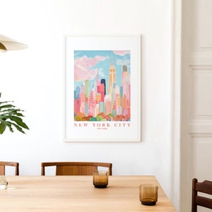 May include: A framed print of a colorful illustration of the New York City skyline with the Empire State Building in the center. The text "NEW YORK CITY" is printed below the image.