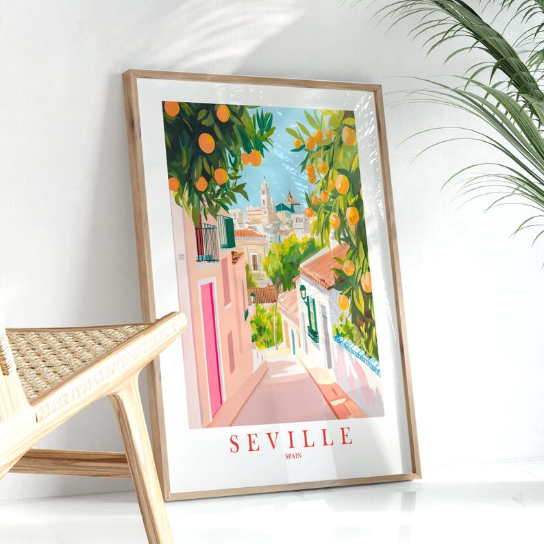 May include: A colorful illustration of a street scene in Seville, Spain. The street is lined with buildings painted in shades of pink and white, with orange trees lining the street. The text "SEVILLE SPAIN" is printed at the bottom of the image.