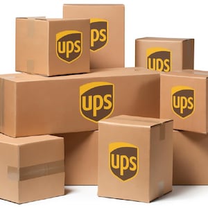 May include: A stack of brown cardboard boxes with the UPS logo printed on each box.