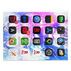 May include: A jigsaw puzzle depicting a digital device interface with app icons, including YouTube, App Store, and Google Maps. The puzzle has a colourful, abstract background with Japanese text. The puzzle is made up of many pieces.