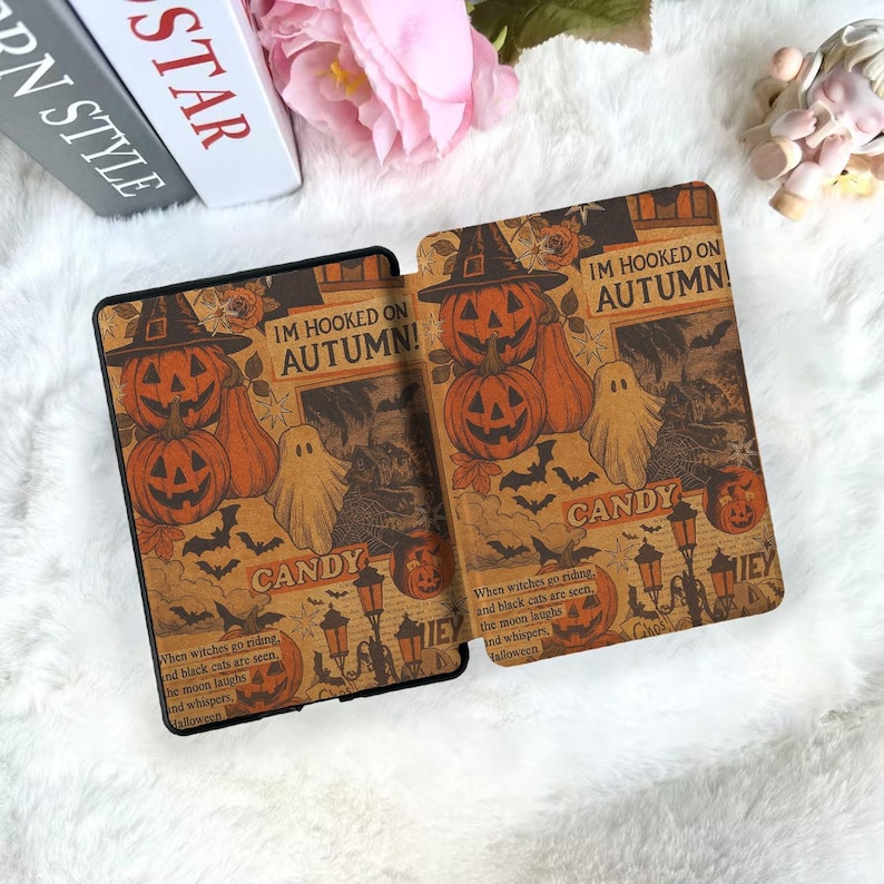 May include: Two Halloween-themed tablet cases with a vintage design. Each case features orange pumpkins, ghosts, bats, and the text "IM HOOKED ON AUTUMN!" and "CANDY" on a brown background. The cases are designed for a tablet.