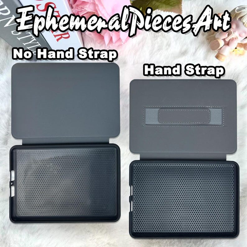 May include: Two gray tablet cases are displayed, one with a hand strap and one without. The cases are open, revealing a black interior with a honeycomb pattern. The text "Ephemeral Pieces Art" is at the top, with "No Hand Strap" and "Hand Strap" labeling each case.