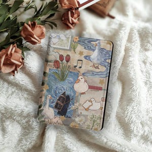 May include: A decorative book cover featuring a whimsical design with ducks, tulips, musical notes, and a starry night sky. The cover has a black border and is set against a soft, white, textured background.