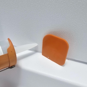 May include: A set of three ceramic mugs with a speckled, matte finish. The mugs are in shades of cream, light gray, and dark gray. Each mug has a simple, minimalist design, perfect for coffee or tea.