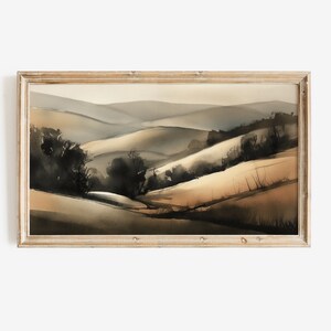 Pode incluir: Uma pintura a aquarela emoldurada de uma paisagem com colinas onduladas e árvores em tons de marrom, cinza e preto.