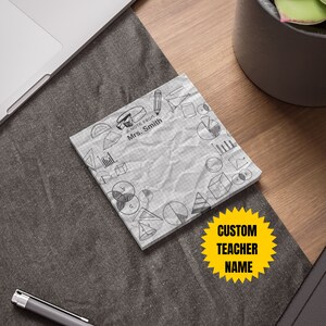 May include: A white notepad with a grid pattern and a crumpled texture. It has a black and white drawing of geometric shapes and the text "A note from Mrs. Smith". A yellow star sticker with the text "CUSTOM TEACHER NAME" is on the notepad.