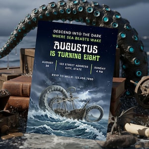 May include: An invitation card with a dark blue background and the text "AUGUSTUS IS TURNING EIGHT". The card features an illustration of a ship being attacked by a giant sea creature. Other elements include a treasure chest, books, and a ship's wheel.
