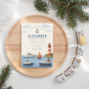 May include: A nautical-themed invitation with the text "Alexander is turning seven!" features a watercolor illustration of boats, a lighthouse, and the words "Sailabration Time." The invitation is on a wooden tray with decorative elements.
