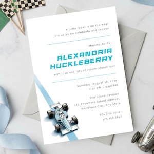 May include: White invitation with blue text and a race car illustration. The invitation reads "A little racer is on the way!" and includes event details. A toy race car and checkered flags are also present.