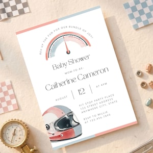 May include: Baby shower invitation with a racing theme. The invitation features a speedometer graphic, a racing helmet illustration, and text that reads "Baby Shower" and details for the event. Pink and blue accents frame the white card.