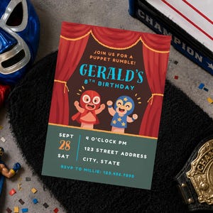 May include: A rectangular birthday invitation card featuring a red curtain backdrop, two cartoon wrestlers, and text that reads: JOIN US FOR A PUPPET RUMBLE! GERALD'S 8TH BIRTHDAY, SEPT 28 SAT, 4 O'CLOCK PM, 123 STREET ADDRESS, CITY, STATE, RSVP TO MILLIE: 123.456.7890.