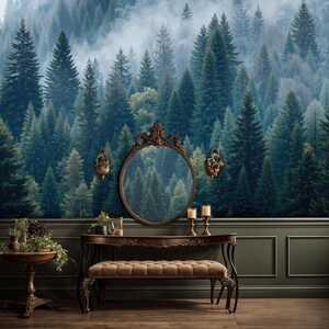 May include: A room with a forest mural wallpaper, a dark wood vanity with a mirror, and a small round table. The vanity has a bench and is decorated with plants and candles. The walls are dark green with white trim.