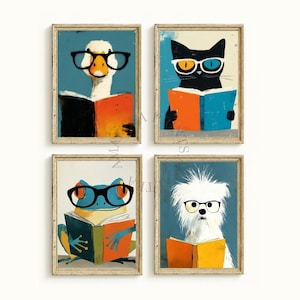May include: Four framed art prints featuring whimsical animal illustrations. A duck, cat, frog, and dog are depicted wearing glasses and reading books. Each print has a blue background and a gold frame, creating a cohesive set.