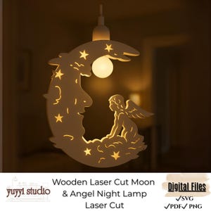 May include: Wooden laser-cut night lamp featuring a crescent moon design with stars and an angel silhouette. The lamp has a warm, glowing light and includes the text "Wooden Laser Cut Moon & Angel Night Lamp Laser Cut".