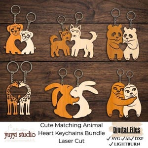 May include: Wooden keychains featuring pairs of animals, each with a heart-shaped cutout. The keychains include dogs, pandas, giraffes, rabbits, and sloths. The keychains are laser cut and come with silver key rings.