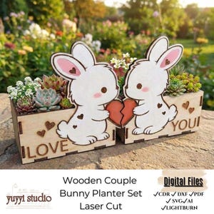 May include: Wooden planter set with two cartoon bunnies holding a broken heart. The bunnies are white with pink accents and brown eyes. The planter boxes are made of wood and contain succulents. The words "I LOVE YOU" are on the boxes.