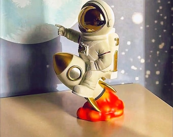 Handcrafted Astronaut Rocket Sculpture: Gold Accent Resin Figurine
