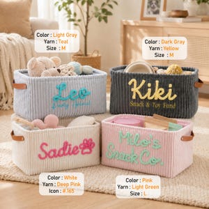 May include: Four rectangular storage baskets with ribbed fabric textures and brown side handles. The light gray basket features teal text 'Leo Party Animal', the dark gray basket has yellow text 'Kiki Snack & Toy Fund', the white basket shows pink text 'Sadie' with a paw print, and the pink basket displays light green text 'Milo's Snack Co.'
