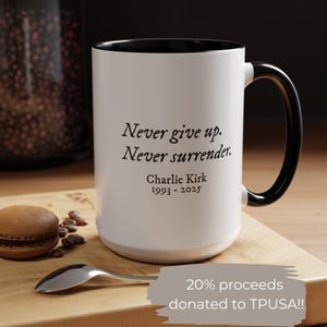 May include: White ceramic mug with a black interior and handle. The mug features the text "Never give up. Never surrender." and "Charlie Kirk 1993-2025." A portion of the proceeds are donated to TPUSA.